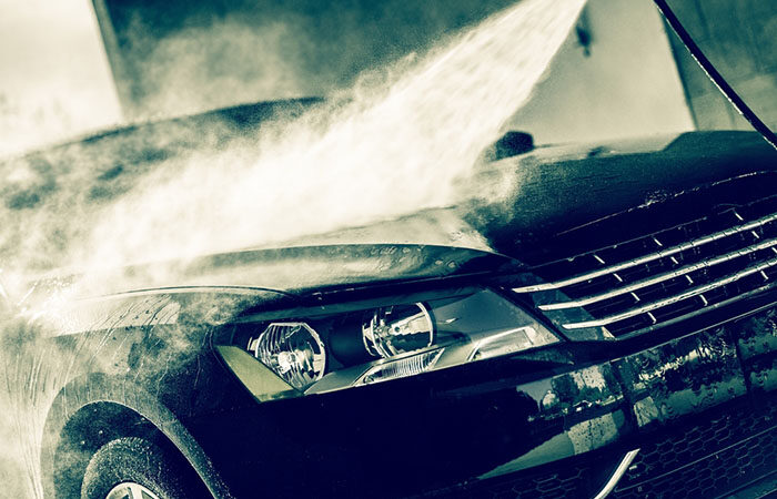 Car,wash,closeup.,washing,modern,car,by,high,pressure,water.